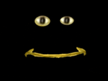 a black background with a gold smiley face with glowing eyes