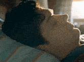 a man is laying in bed with his eyes closed and the word kepler is on the bottom
