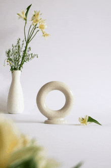a vase with flowers in it and a vase with a circle in the middle