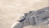 a fighter jet with the number 14 on its nose