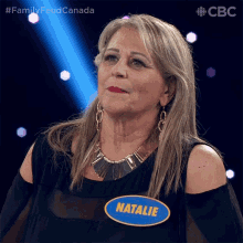 a woman wearing a name tag that says natalie on it