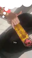 a person wearing a black shirt that says drip on the bottom