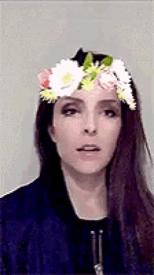 a woman wearing a floral crown on her head .