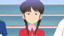 a cartoon girl with pigtails is making a funny face while sitting in a stadium .
