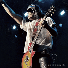 a man playing a red guitar with the word pils on it