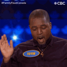 a man with the name toyin on his shirt