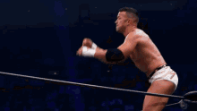 a wrestler with a belt that says g on it is laying on his back
