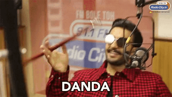 a man wearing sunglasses and a plaid shirt says 