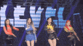 a group of women are dancing in front of a large sign that says level