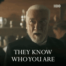 a man with white hair and a beard says " they know who you are "