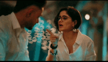 a man and a woman are talking and the woman is pointing