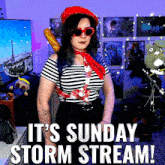 a woman wearing sunglasses and a red hat stands in front of a sign that says it 's sunday storm stream !