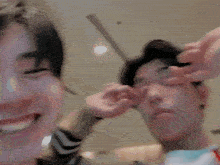 a blurry picture of two men holding each other 's faces .