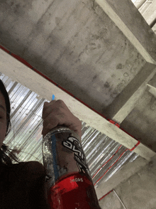 a woman is holding a bottle of sky high soda