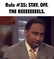 a man in a suit and tie with rule # 35 written above him