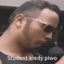 a man wearing sunglasses says " student kiedy piwo " in a foreign language