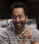 a man with a beard is smiling and saying i don t think this guy 's a good guy