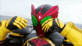 a man in a superhero costume with a helmet and gloves