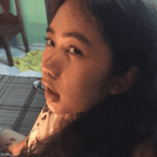 a close up of a girl 's face with imgflip.com at the bottom right