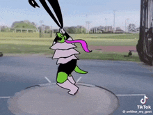 a cartoon character is standing on top of a throwing disc .
