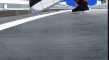 a person wearing a black shoe with a white sole is walking on a road