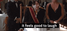 a man sitting in a chair with the words it feels good to laugh