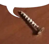 a close up of a screw on a brown surface