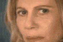 a close up of a woman 's face with a triangle on it and a mathematical formula .