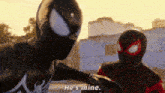 a man in a spiderman suit is standing next to another man in a spiderman suit and talking to him .