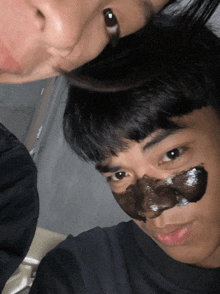 a man has a black mask on his face