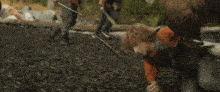 a boy is holding an arrow in the water while a man stands behind him .