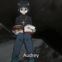 a cartoon character reading a book with the name audrey on the bottom