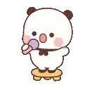 a panda bear is standing on a stool holding a microphone and blowing a bubble .