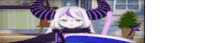 a cartoon character with purple horns is sitting on a blue couch .