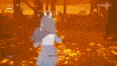 a girl is holding a stick in a video game while surrounded by flames .