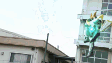 a robot is flying in the air in front of a building .