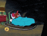 a cartoon jerry is sleeping in a bed with a blue blanket