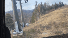 a view of a ski lift going up a hill