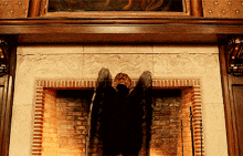 a fireplace with a statue of a bird on top