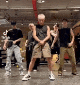 a group of young men are standing next to each other in a gym .