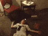 a woman in a white dress is laying on the floor near a box that says first aid