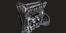 a close up of a car engine with pistons and a chain