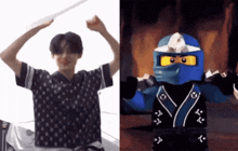 a man in a black and white shirt is next to a lego ninja