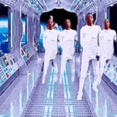 a group of people in white clothes are dancing in a futuristic hallway .
