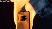 a phone that is on fire with the sanda media logo on the bottom