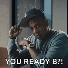 a man wearing a hat and a watch says " you ready b ? "