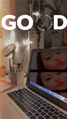 a laptop with a picture of a woman on the screen is on a desk with the words good above it