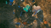 a group of people are laying in the dirt looking for treasures .