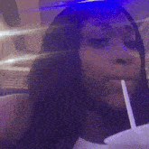 a blurry picture of a person 's face with a purple light behind them