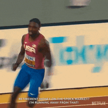 a man in a usa shirt is running on a track